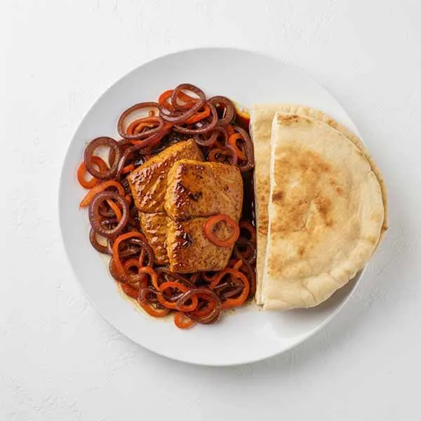 Roasted fish with Pomegranate molasses Braised onion peppers & khubz